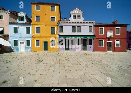 Burano Insel, Lagune von Venedig, Venedig, Italien, Panorama mit den typischen farbigen Fischerhäusern auf einem Platz im Dorfzentrum Stockfoto