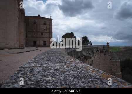 Blick auf das Kloster von Uclés von den Umfassungsmauern unter einem bewölkten Himmel im Frühjahr, Cuenca, Spanien Stockfoto