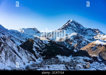 Der Sonnenuntergang Blick auf schneebedeckten Berg Kazbegi, in Georgien. Stockfoto