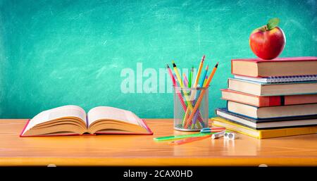 Apple On Stack Books With Supplies - Back To School Stockfoto