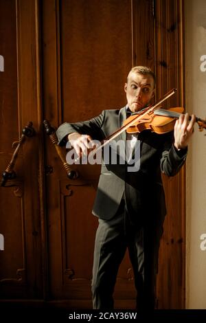 Junge professionelle Musiker Mann spielen Geige, üben, klassische Musik. Musik, Instrumente, Kunstkonzept Stockfoto