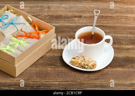 Bar mit Müsli, eine Tasse Tee und Boxen mit Bars. Gesundes Frühstück Stockfoto