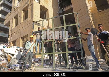 Beirut, Libanon. August 2020. Menschen reinigen Trümmer nach Explosionen in Beirut, Libanon, 9. August 2020. Die beiden großen Explosionen, die Beirut am 4. August erschüttert haben, haben mindestens 158 Menschenleben gefordert und 6,000 weitere verletzt. Quelle: Bilal Jawich/Xinhua/Alamy Live News Stockfoto