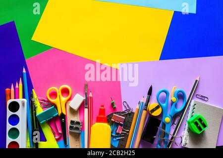 Schulbedarf für das Studium auf einem mehrfarbigen Hintergrund mit Platz Für Text Stockfoto