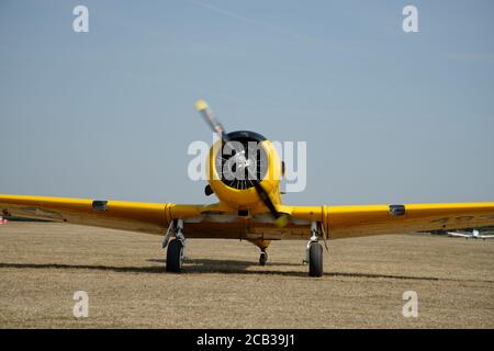 Gelbes Triebfahrzeug auf dem Flugplatz Headcorn. T6 Harvard-Flugzeuge Stockfoto