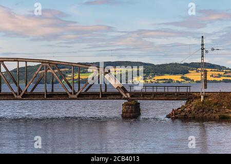 Blick auf eine alte Eisenbahn- und Hoflandschaft in der Hintergrund beleuchtet von der Sonne an einem schönen Sommer Tag in Hamar Norwegen 2020 August 9 Stockfoto