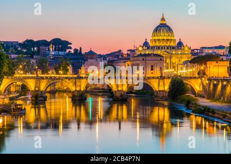 Blick auf den Petersdom und die Vatikanstadt bei Sonnenuntergang am Tiber in Rom, Italien Stockfoto