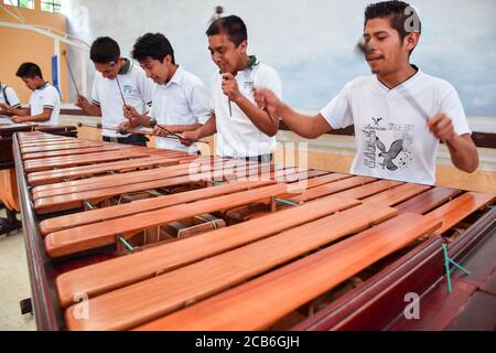 Guatemala City / Guatemala - 27. August 2015: Gruppe junger indigener Studenten, die traditionelles Xylophon-ähnliches Holzinstrument spielen Stockfoto