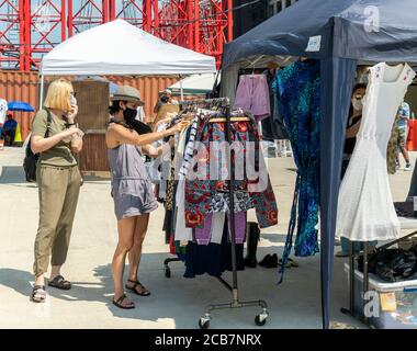 Am Eröffnungstag, Sonntag, 9. August 2020, erdulden die Käufer die Hitze auf dem Greenpoint Terminal Market. Der Markt behielt die extrabreiten Gänge aufrecht, eine Voraussetzung für Gesichtsbedeckung und soziale Distanzierungsprotokolle, da Käufer handwerkliche und antike Waren sowie eine Auswahl von Lebensmittelhändlern durchstöberten. (© Richard B. Levine) Stockfoto