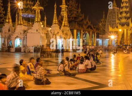 Yangon, Myanmar - 18. Dezember 2017: Langzeitbelichtung von Burmesen, die in der Shewdagon Pagode in Yangon, Myanmar beten Stockfoto