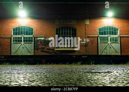 Ein altes Lagerhaus in der Nacht, Tore eines alten Lagerhauses, Verladerampen eines alten Lagerhauses Stockfoto