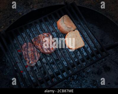 Zwei saftige Steaks und zwei kleine Brotscheiben Der Grill Stockfoto