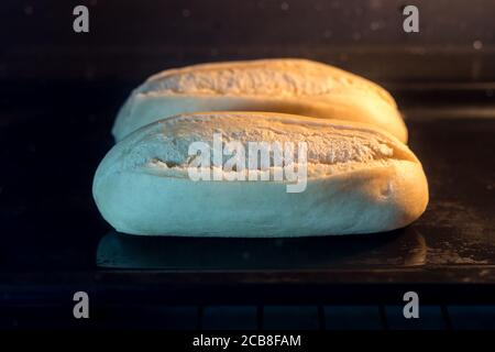 Mini-Brot backen noch roh im Ofen bereit Frisch zubereitet werden Stockfoto