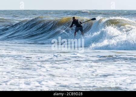 Paddle-Surfen im Sommer vor dem tropischen Sturm Isaias in Jacksonville Beach, Florida. (USA) Stockfoto