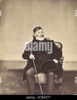 [Sitzender Mann mit Stock und Hut], 1850er-60er Jahre. Stockfoto