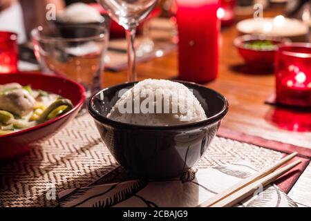 Thaï Reis in einer schwarzen Keramikschale. Nahaufnahme des Essens. Köstliche asiatische Beilage. Der Reis ist kugelförmig. Stockfoto