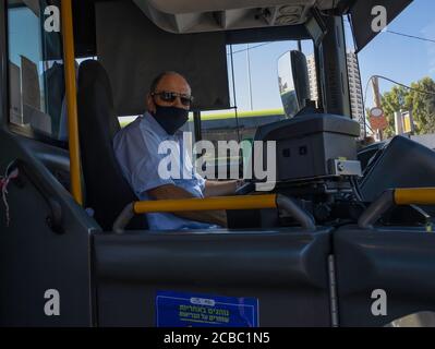 Jerusalem, Israel - 6. August 2020: Ein israelischer Busfahrer mit einer COVID Maske in Jerusalem. Stockfoto