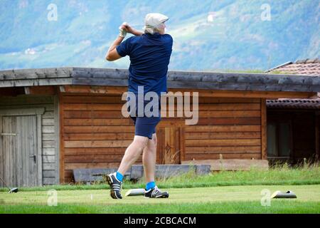 Verschwommene Bewegung eines männlichen Golfers beim Abschlag im Blue Monster Golfclub in Südtirol, Italien im Sommer 2020. Stockfoto