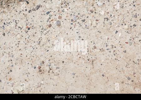 Erdstruktur mit winzigen Steinen, abstrakte Sandstruktur Stockfoto