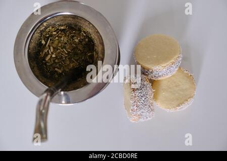 Argentinische Tradition: Nahaufnahme von köstlichen Maisstärke-Alfajores auf dem Tisch vor dem heißen Aufguss von Yerba Mate Stockfoto