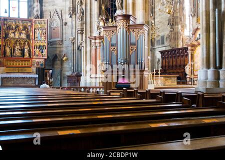 Innenansicht der großen Pfeifenorgel und Reihen von Holzbänken und Altar des Stephansdoms, Stephansdom. In Wien, Österreich. Stockfoto