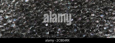 Hintergrundtextur aus schwarzem luftdichtem Schaumgummi Stockfoto