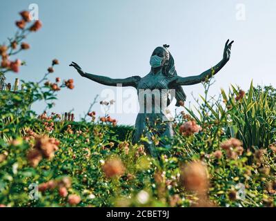 Coronavirus Sommer - Statue von Dame Margot Fonteyn trägt eine Gesichtsmaske während der Covid 19 Pandemie in Reigate, Surrey, England 2020 Stockfoto