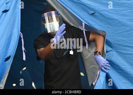 New York City, USA. August 2020. Ein Arzt ruft eine wartende Person in ein Zelt, um einen kostenlosen COVID-19-Test im Sunset Park im Stadtteil Brooklyn von New York City, NY, durchzuführen, 13. August 2020. New York City Bürgermeister Bill de Blasio kündigte "Hyper-lokale" Coronavirus-Tests als Reaktion auf. Höhere Infektionsraten und niedrige Testraten im Sunset Park Abschnitt von Brooklyn. (Anthony Behar/Sipa USA) Quelle: SIPA USA/Alamy Live News Stockfoto