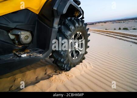 Geländewagen atv Nahaufnahme Detail großen Reifen, nicht erkennbar. Nahaufnahme des ATV-Rades. Tourist auf dem Quad fährt durch die sandige Wüste Stockfoto