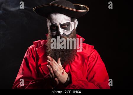 Mann verkleidet wie ein unheimlicher Pirat für halloween Feier auf schwarzem Hintergrund. Stockfoto