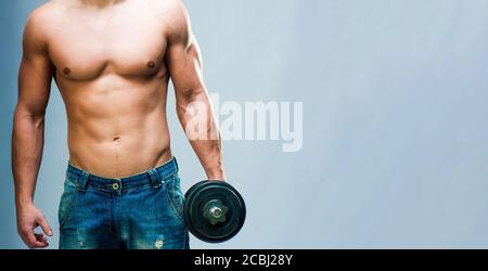 Muskulöser Mann mit Gewichten auf grauem Hintergrund mit Kopie Platz Stockfoto
