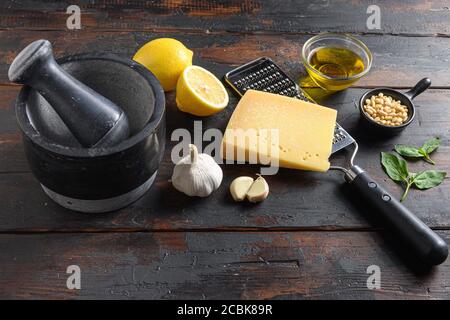 Italienische Lebensmittel Kochen Zutaten für Pesto-Sauce Basilikum, Olivenöl, Parmesan, Knoblauch, Pinienkerne. Auf dunklen rustikalen Holztisch Stockfoto