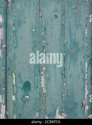 Vertikale Planken mit abblätternder blau-grüner Farbe Stockfoto