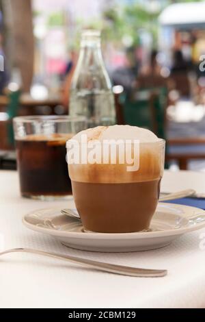 Nahaufnahme einer Tasse Cappuccino auf dem Tisch im mediterranen Café Mit unscharfem Hintergrund Stockfoto