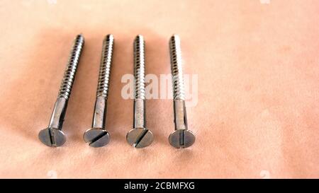 Stahlschrauben, die in den verschiedensten Bauarten auf weißem Hintergrund verwendet werden, selektiver Fokus Stockfoto