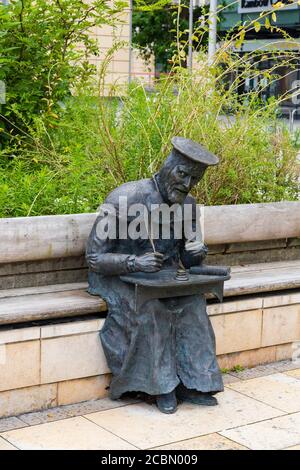 Bronzestatue des sitzenden William Tyndale, protestantischer Reformator, von Thomas Holocener. Millenium Square, Bristol England. Juli 2020 Stockfoto