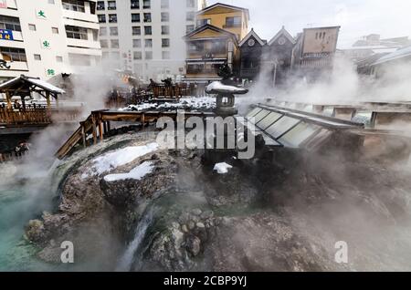 Tagesansicht von Yubatake, einem Hauptsymbol von Kusatsu Onsen, wo heißes Wasser durch Holzkanäle aus Pinienwald strömt. Stockfoto