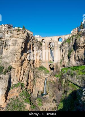 Brücke Puente Nuevo mit Wasserfall an steilen Klippen, Tajo Schlucht und Fluss Rio Guadalevin, Ronda, Provinz Malaga, Andalusien, Spanien Stockfoto