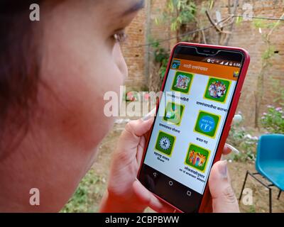 DISTRIKT KATNI, INDIEN - 27. APRIL 2020: Ein indisches Mädchen zeigte gram panchayat marathi Portal auf Smartphone-Bildschirm, für E-Schema Awareness-Konzept. Stockfoto