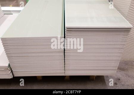 Palette mit Trockenwandplatten Gipskarton im Lagerhaus des Gebäudes. Stockfoto