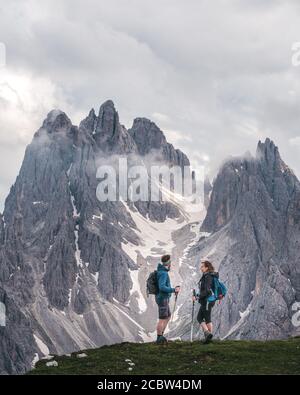 Zwei Wanderer stehen und reden, mit beeindruckenden schroffen Gipfeln der Cadini di Misurina Berggruppe hoch im Hintergrund Stockfoto