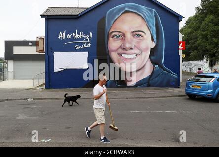 Danny Doyle, Pate und Onkel von Schwester Clare Crockett, tippte vor einem neuen Wandbild von Schwester Crockett die Straße vor einem Segensgottesdienst für das Wandbild am Sonntagabend auf. Das Wandgemälde von Schwester Crockett, die 2016 bei einem Erdbeben in Ecuador ums Leben kam, wurde von der Firma UV Arts in der Nähe ihres Hauses im Brandywell, Derry, gemalt. Stockfoto