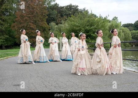 Eine kleine Gruppe von Paraguayer amerikanischer Volkstänzern in einheimischen Kostümen posieren für Fotos. In einem Park in Flushing, Queens, New York City. Stockfoto