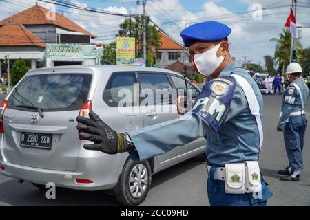Denpasar, Bali, Indonesien. August 2020. Offiziere, um den Verkehr zu verwalten, bevor die Zeremonie beginnt. Polizei und Militär hielten die Zeremonie zum Gedenken an den 75. Indonesischen Unabhängigkeitstag in der Mitte der Autobahnkreuzung ab. Indonesien wurde am 17. August 1945 zur Unabhängigkeit erklärt. Kredit: Dicky Bisinglasi/ZUMA Wire/Alamy Live Nachrichten Stockfoto