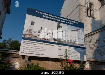 Putbus, Deutschland. August 2020. Zwischen zwei baufälligen Stadtvillen gibt es ein Schild, das eine hochwertige Restaurierung der Gebäude ankündigt. 18 hochwertige Eigentumswohnungen sollen gebaut werden. Die Gebäude gehören zum zentralen Platz der Stadt Putbus auf der Insel Rügen, dem CIRCUS. Es wurde 1833 im Auftrag von Fürst Graf Wilhelm Malte von Putbus erbaut. Ein Obelisk bildet die genaue Mitte des Quadrats. Quelle: Stephan Schulz/dpa-Zentralbild/ZB/dpa/Alamy Live News Stockfoto