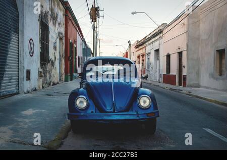 Merida, Yucatan, Mexiko - 20. November 2018: Alte blaue Volkswagen Käfer in den kolonialen Straßen bei Sonnenuntergang Stockfoto