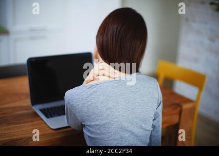Nahaufnahme einer Brünette Frau massiert ihren Hals oder Schulter. Stockfoto