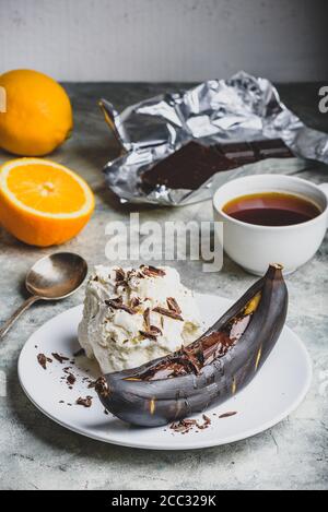 Gegrillte Banane mit dunkler Schokolade und Vanilleeis. Stockfoto