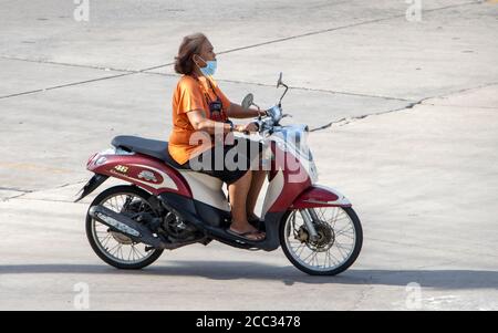 SAMUT PRAKAN, THAILAND, JULI 01 2020, eine Frau fährt auf dem Motorrad auf der sonnigen Straße. Stockfoto