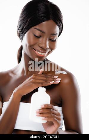 afroamerikanische Frau Anwendung Körperlotion isoliert auf weiß Stockfoto